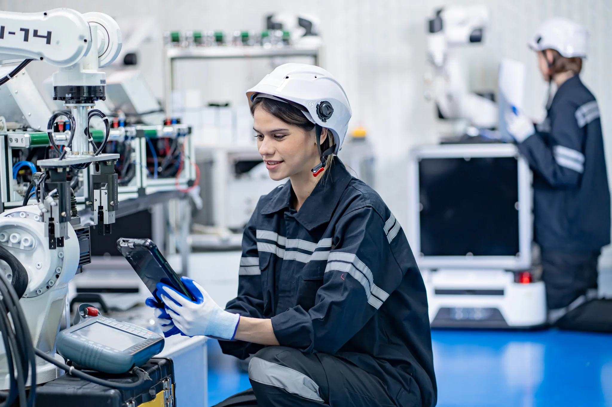 Engineer using digital tablet in futuristic manufacturing workplace